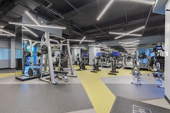 A gym with weights and cardio equipment in a building